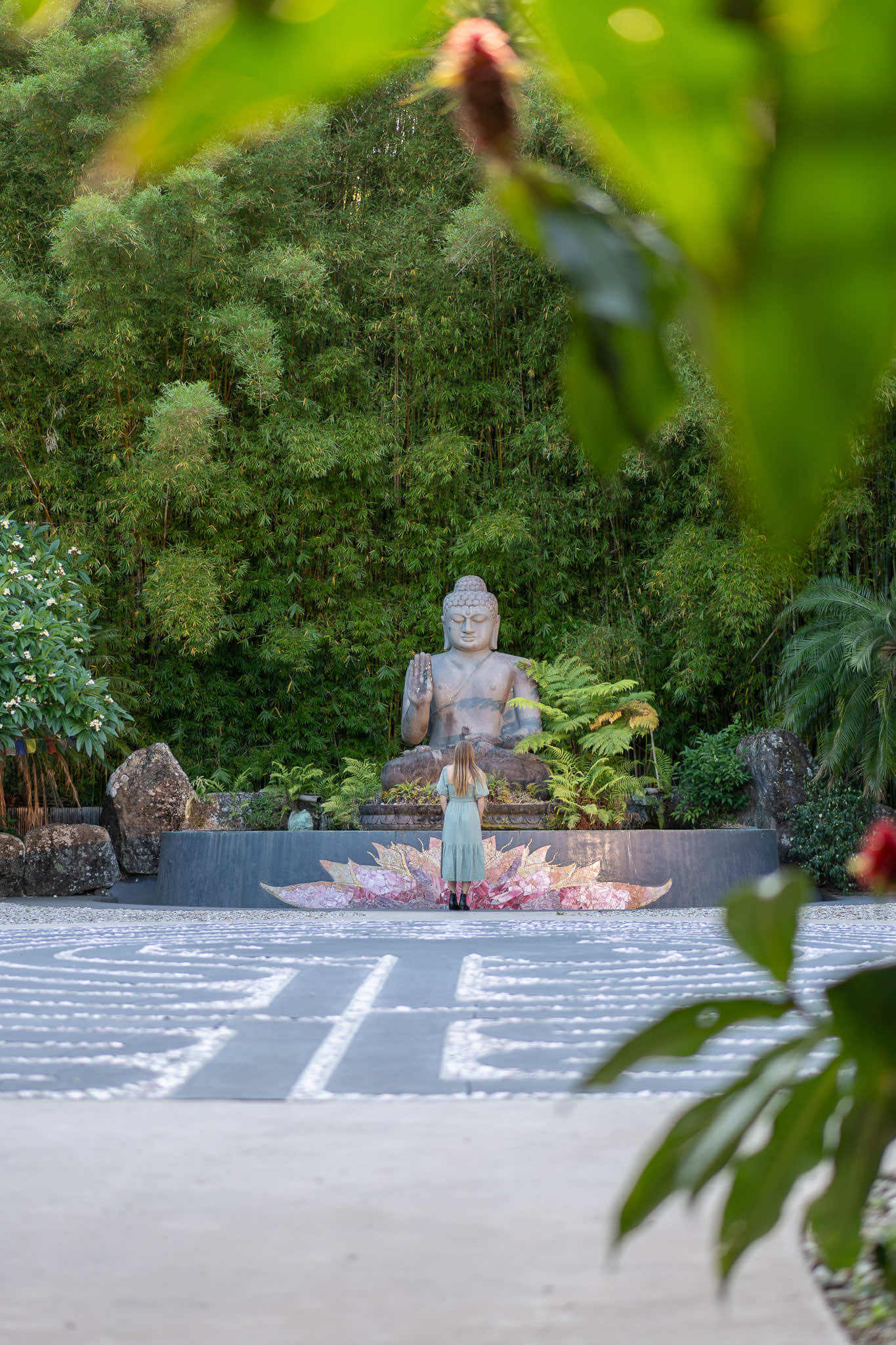 The Blessing Buddha and Crystal Labyrinth through foliage